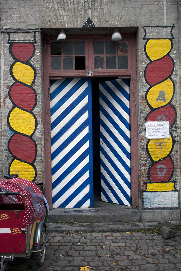 Photo 01443: Worn double door in blue, white, red, and yellow with top window