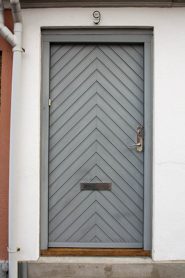 Photo 01791: Panelled, light grey door with diagonal boards