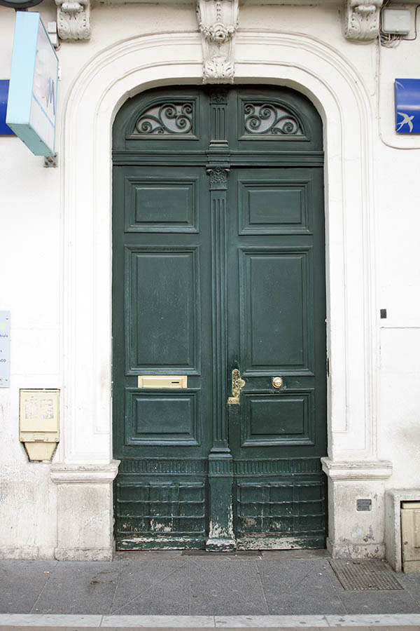 Photo 02208: Worn, panelled, green double door with latticed top windows