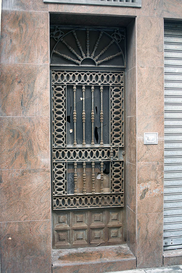 Photo 02818: Worn, unpainted metal door with top window