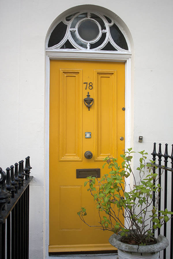 Photo 04611: Panelled, yellow door with decorated fan light