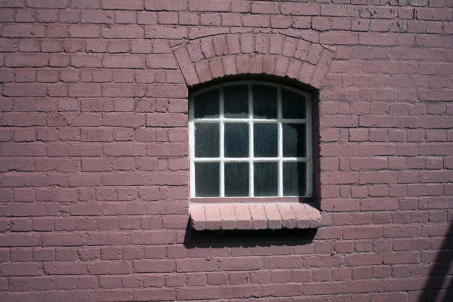 Photo 04946: White, formed, metal window in a cerise wall