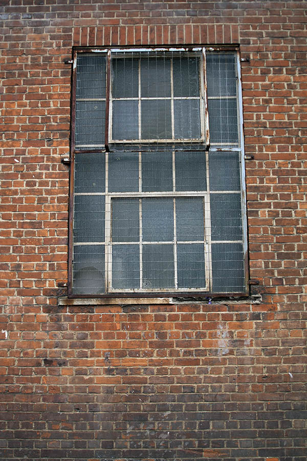 Photo 05174: Worn, large, white window with 25 panes and thin lattice