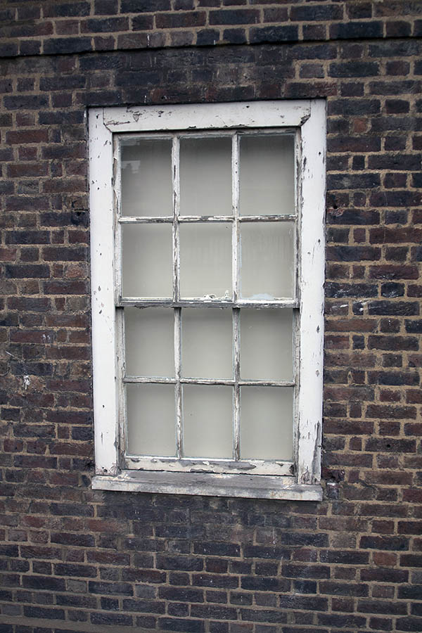 Photo 05189: Worn, white sash window with 12 panes