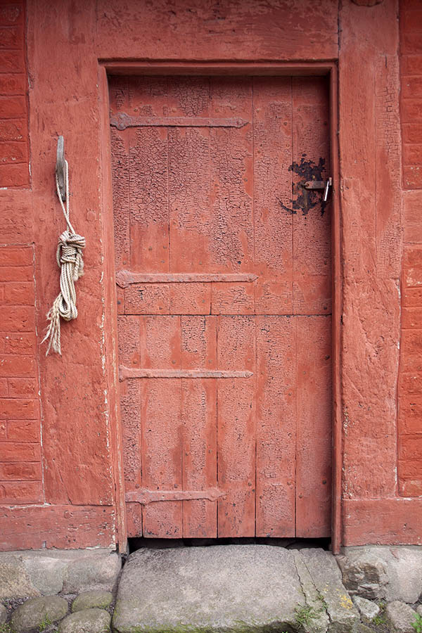 Photo 07246: Worn, red half-door made of planks
