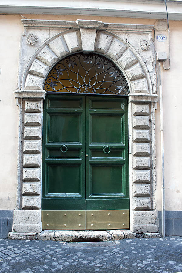 Photo 08077: Panelled, green double door with latticed fan light and pilaster