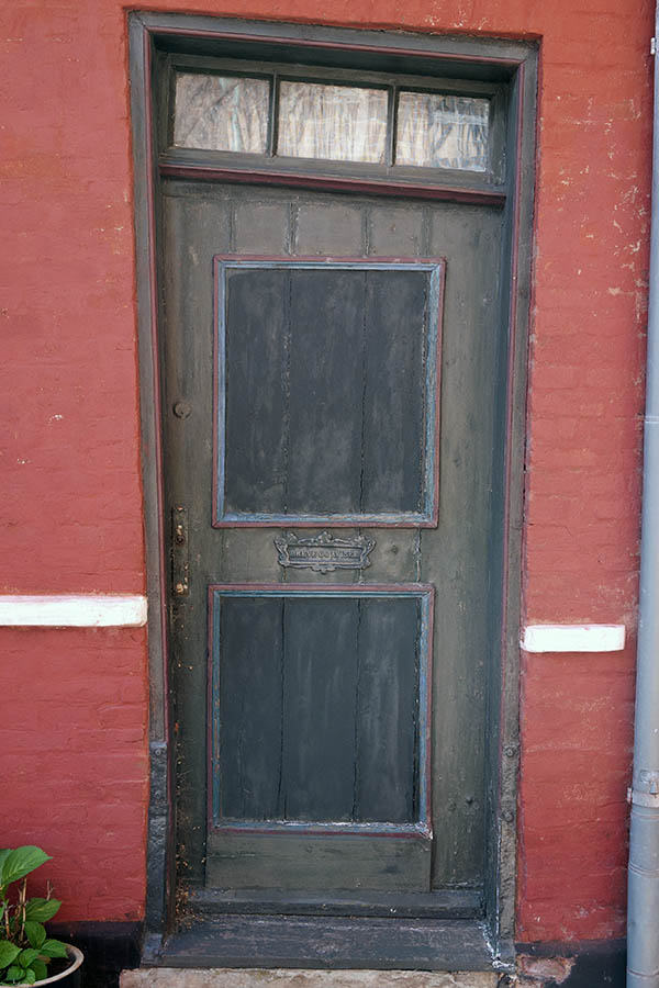 Photo 08697: Lopsided, green, blue, and red door with top window