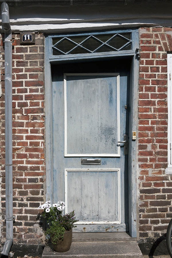 Photo 08769: Lopsided, panelled, decayed, light blue and white door with top window