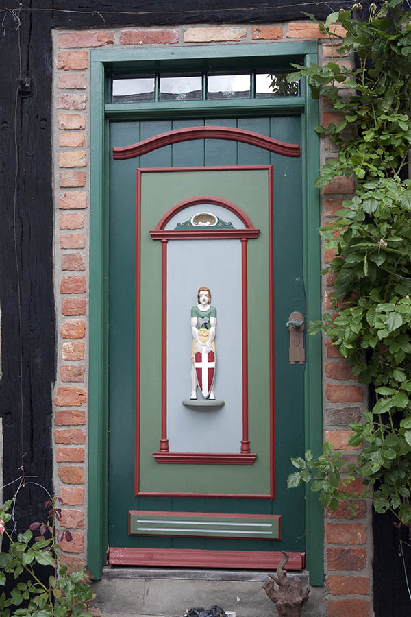 Photo 08808: Carved, panelled green, light green, red and grey door with door light