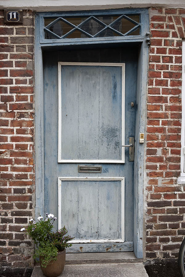 Photo 08941: Very lopsided, decayed, panelled, light blue and white door with top window