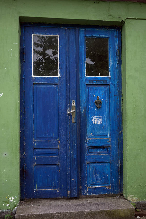 Photo 09078: Worn, panelled, blue double door with door lights