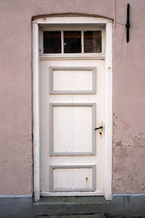 Photo 09376: Worn, panelled, grey and white door with top window