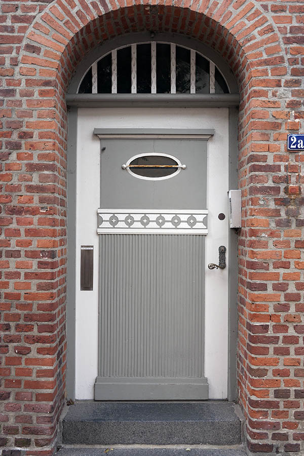 Photo 09405: Carved, panelled grey and white door with fan light and door light