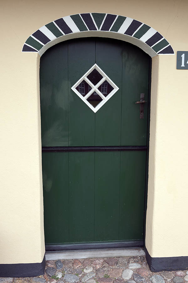Photo 09756: Formed, green and white half-door made of planks with a diamond-shaped door light