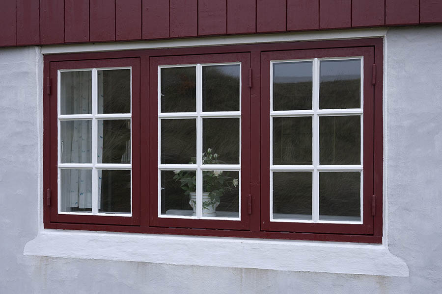 Photo 09760: Red and white window with three frames and 18 panes
