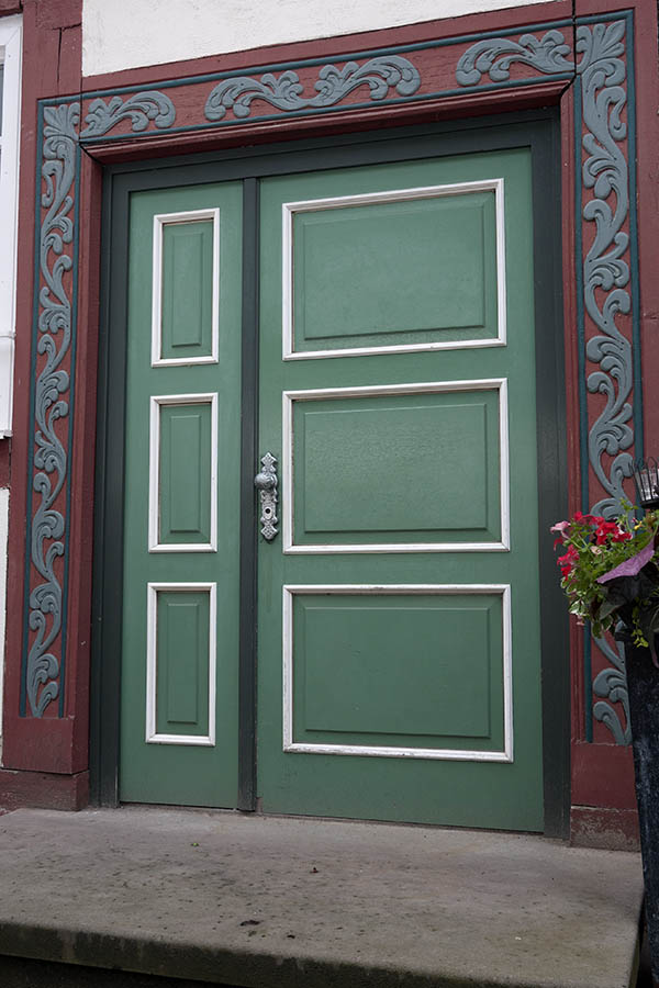 Photo 11999: Panelled, green and white door with sidepiece and carved, red and grey pilaster