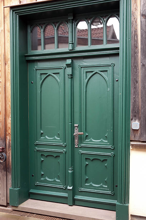 Photo 12292: Carved, panelled, green double door with top window