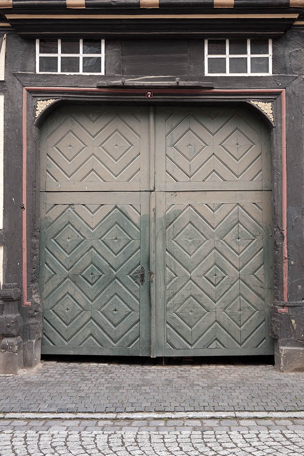 Photo 12376: Worn, panelled, green gate with minor door