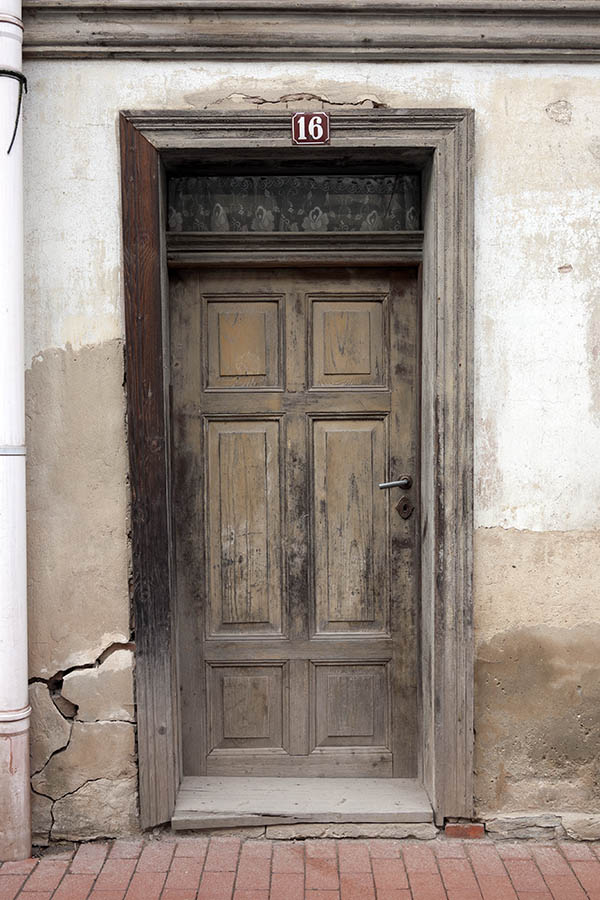 Photo 12480: Worn, panelled, unpainted door with top window