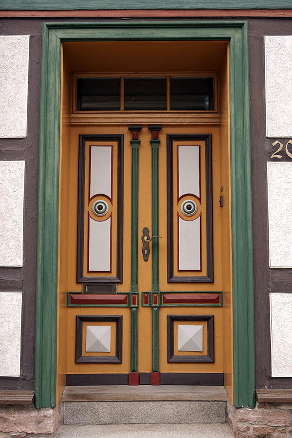 Photo 12652: Carved, panelled, yellow, green, brown, red and white double door with top window