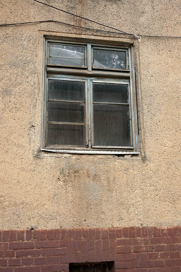 Photo 12807: Worn, teal window with four frames and seven panes