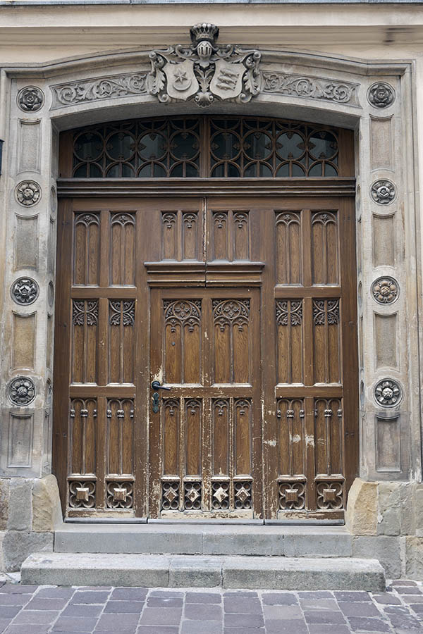 Photo 13619: Worn, carved, panelled, brown door with sidepieces and top window