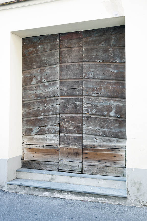 Photo 14769: No door. A wide, door covered with spiked, brown, unpainted planks.