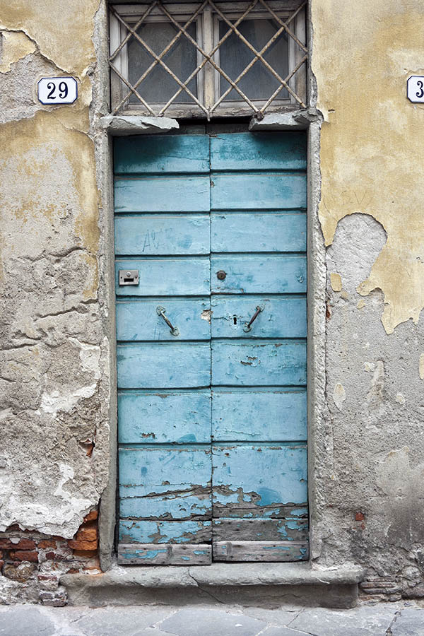 Photo 15182: Decayed, light blue double door made of planks with barred, white top window