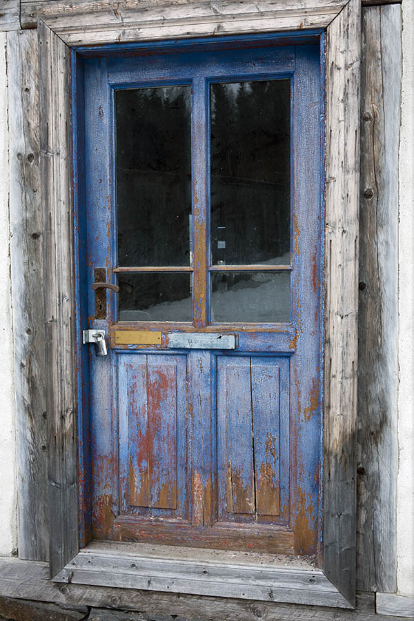 Photo 17389: Worn, panelled, blue and unpainted door with door lights