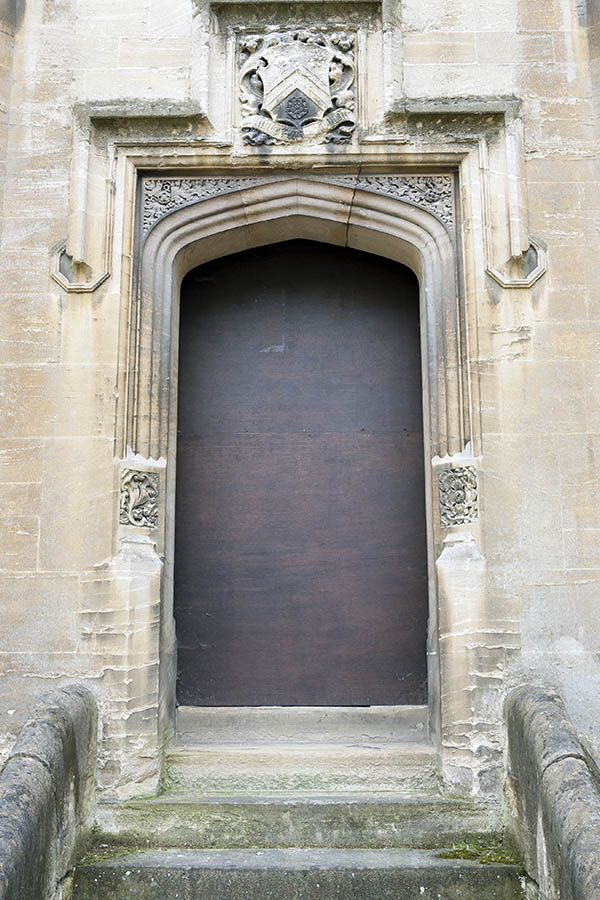 Photo 18823: No door. A door blocked with brown plywood. Mounted in a large sandstone pilaster.