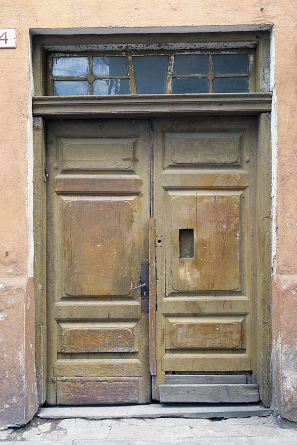 Photo 20166: Worn, panelled, green double door with top window