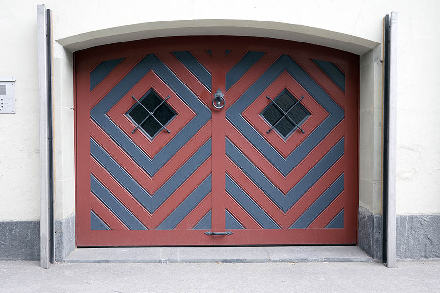 Photo 23875: Formed, red and blue garage door with barred, diamond-shaped door lights