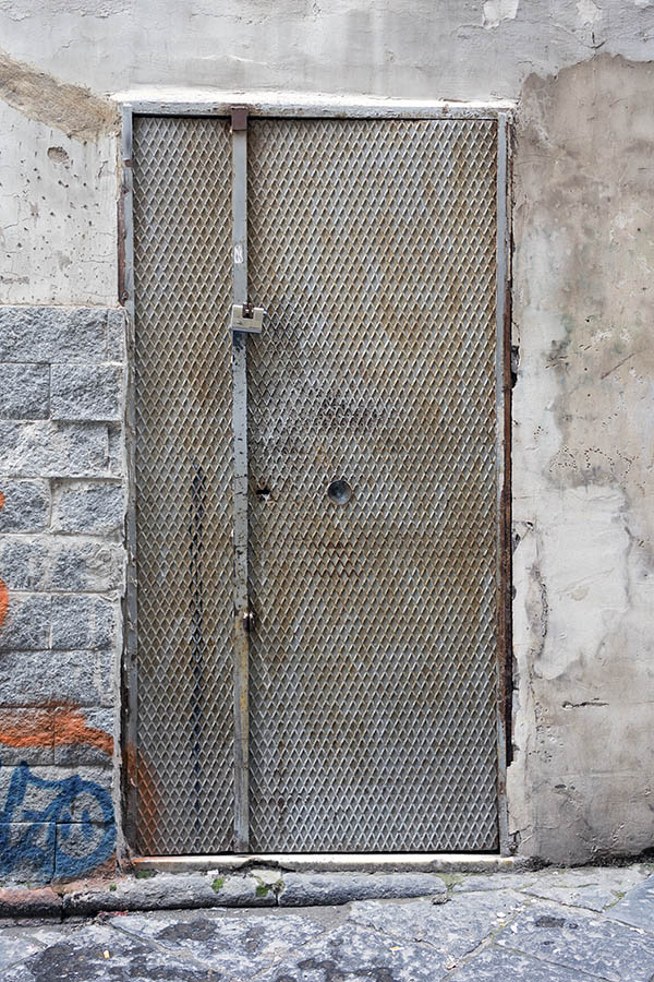 Photo 23905: Worn, grey metal plate door with sidepiece