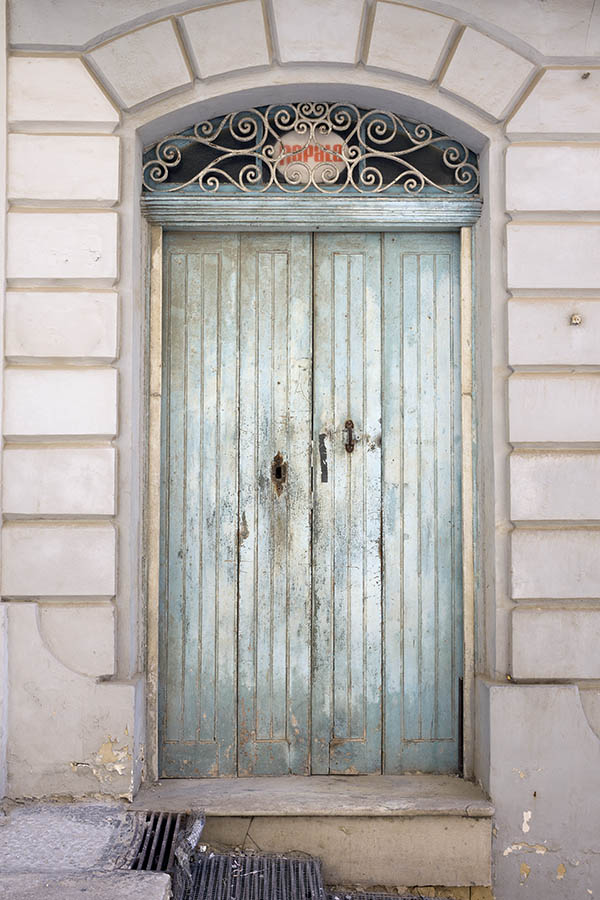 Photo 24089: Worn, narrow, panelled light blue door in four parts with latticed fan light