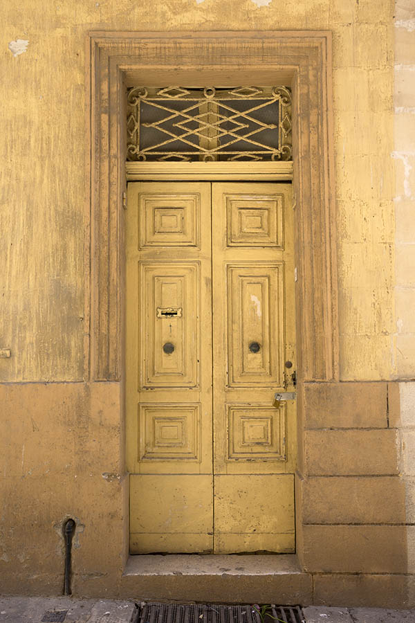 Photo 24110: Worn, panelled, yellow double door with latticed top window