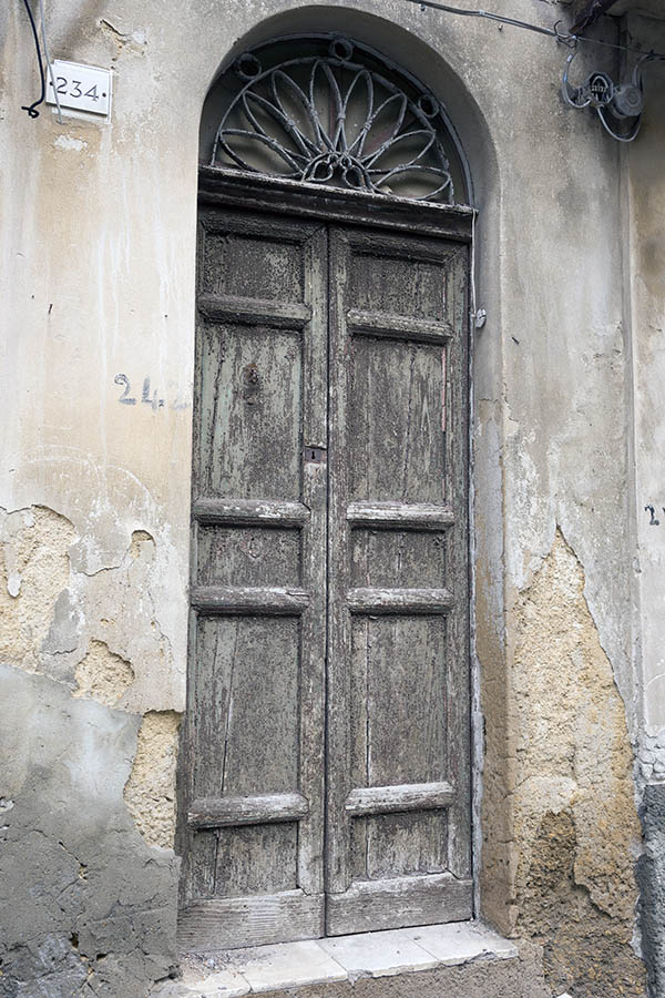 Photo 24466: Decayed, panelled, unpainted double door with latticed fan light