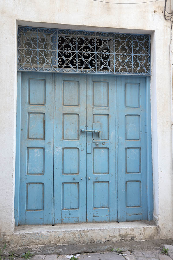 Photo 24583: Worn, panelled, carved, light blue gate with latticed top window