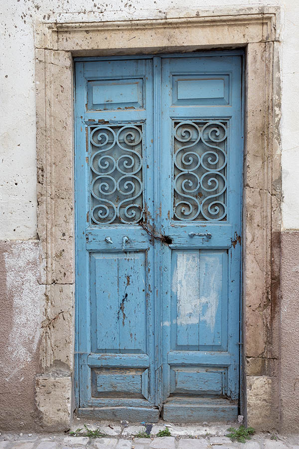 Photo 24587: Decayed, panelled, lopsided, light blue double door with latticed door lights