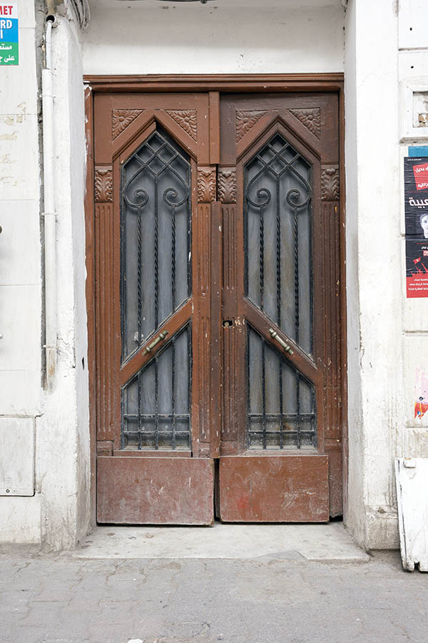 Photo 24596: Worn, panelled, carved, brown double doors with latticed door light