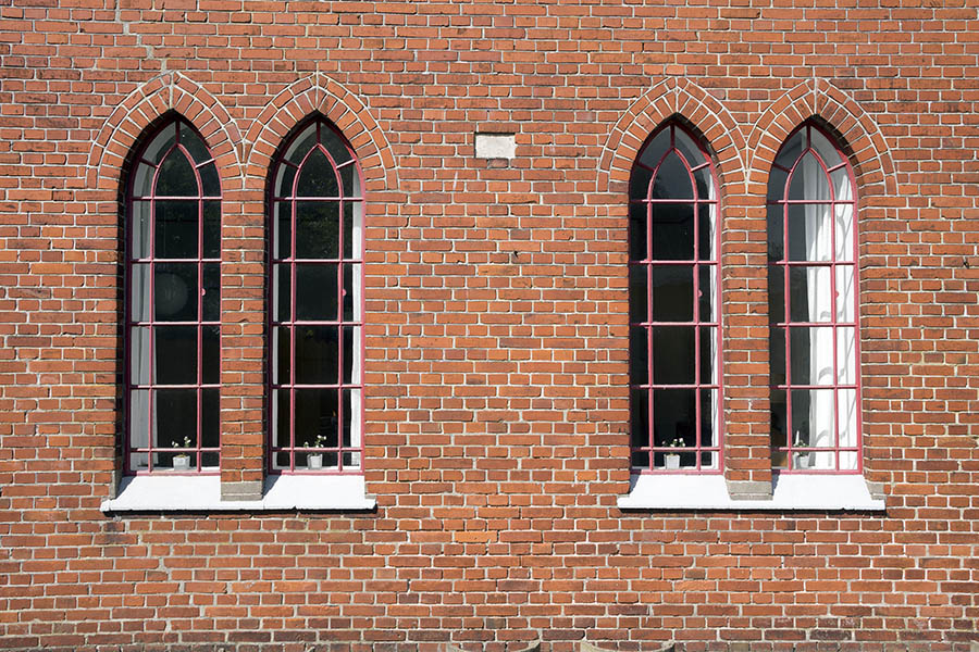Photo 25231: Facade with four narrow, red metal windows with 20 panes each
