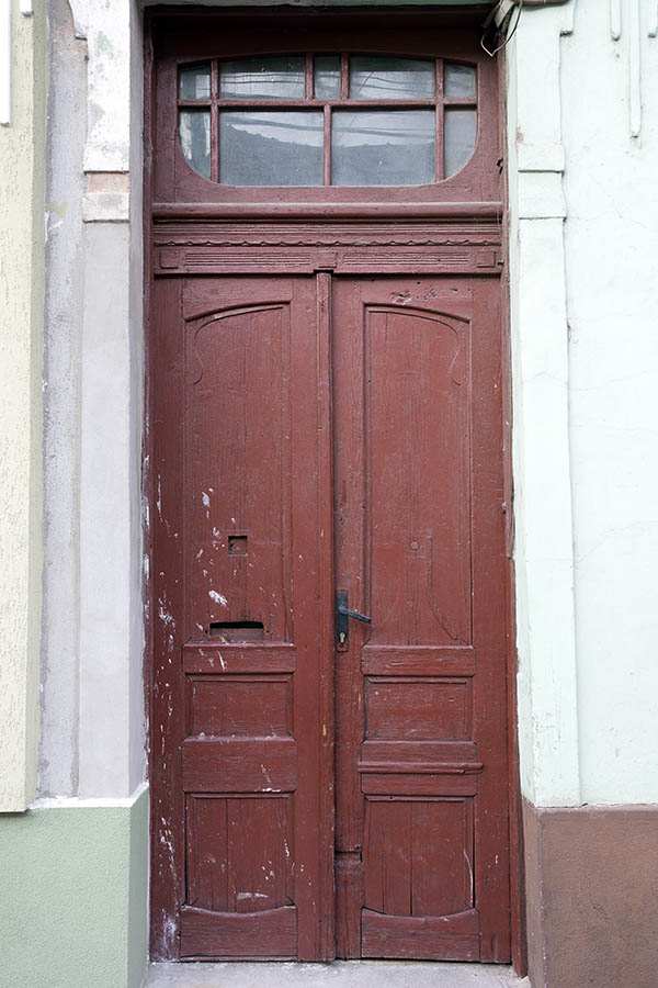Photo 25581: Worn, panelled, formed, carved, red double door with top window