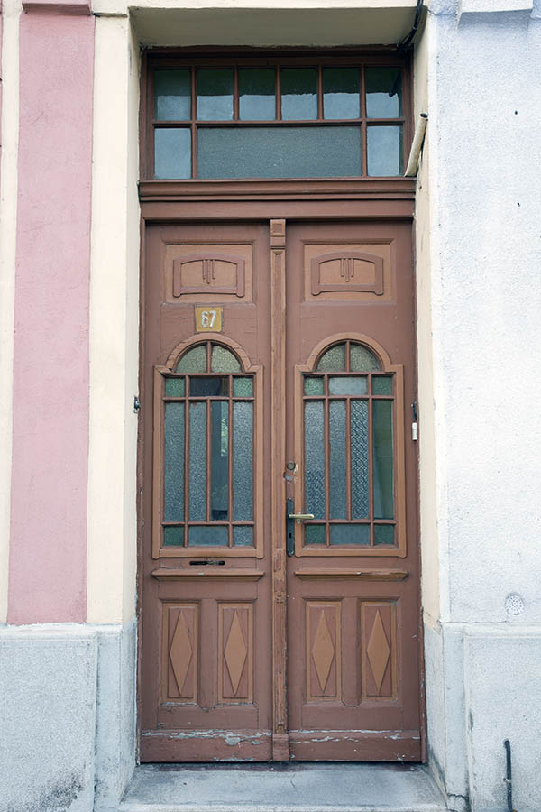 Photo 25597: Narrow, panelled, carved, orange and brown double door with formed door lights