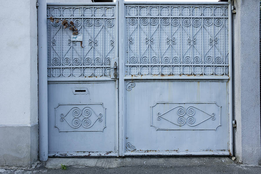 Photo 25642: Grey or blue metal gate with door and decorations