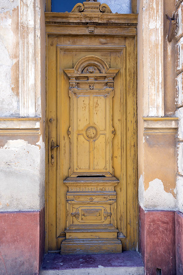 Photo 25719: Worn, panelled, carved, yellow door