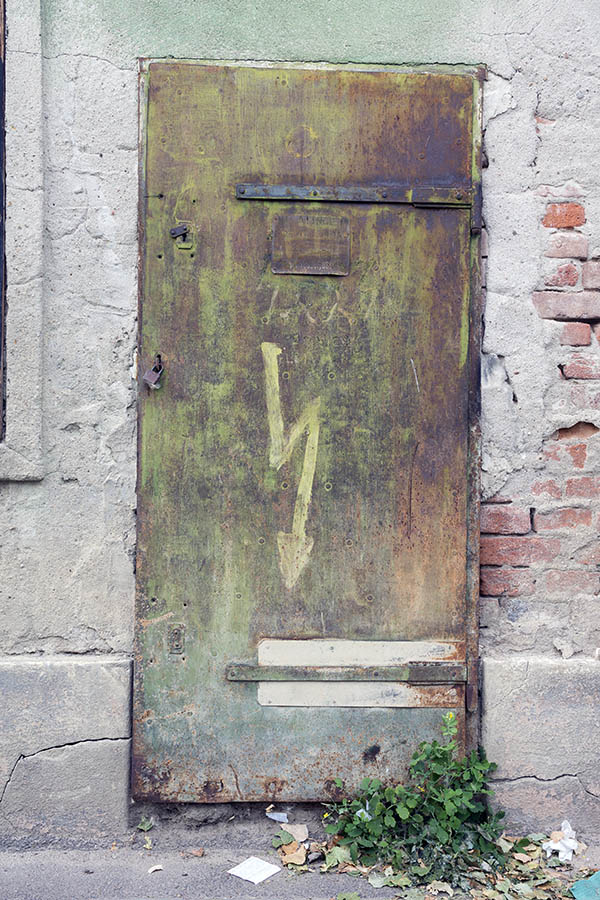 Photo 25756: Worn, rusty, brown metal plate door