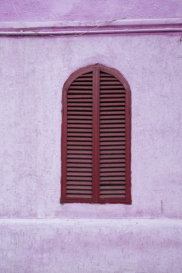 Photo 25782: Window with red, formed shutters in a pink wall