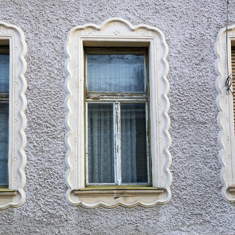 Photo 25844: Worn, carved, green window with three panes