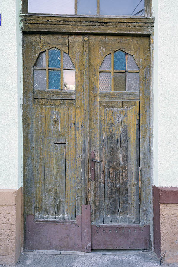 Photo 25850: Decayed, panelled, yellow and unpainted double door with formed door lights and top window