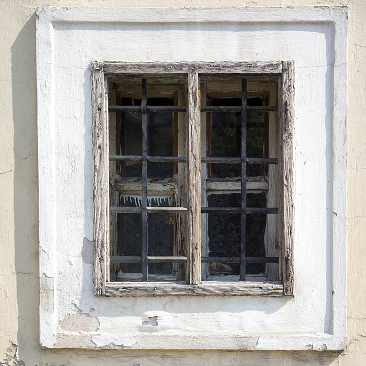 Photo 26000: Little, worn, barred, white and unpainted window with four panes