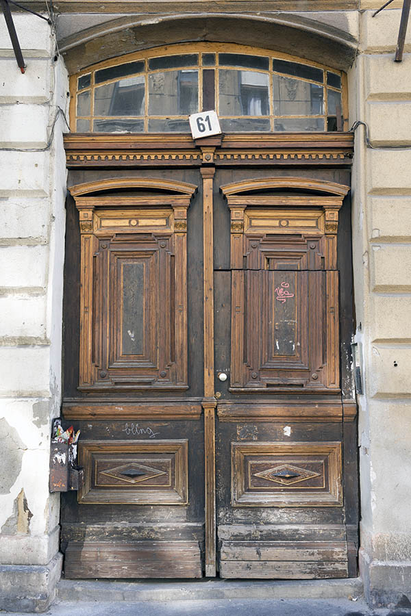 Photo 26088: Worn, panelled, brown and oiled, carved double door with fan light and minor door